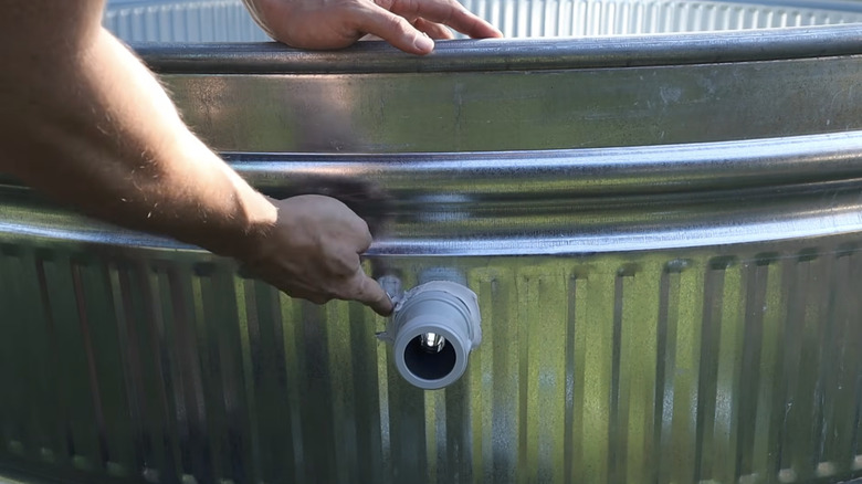 Finger smoothing plumbers putty on DIY pool valve