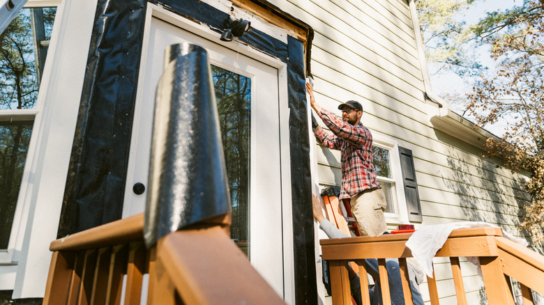 person undertaking a DIY construction on their front door