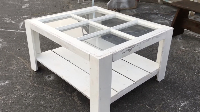 A white coffee table made out of a vintage window