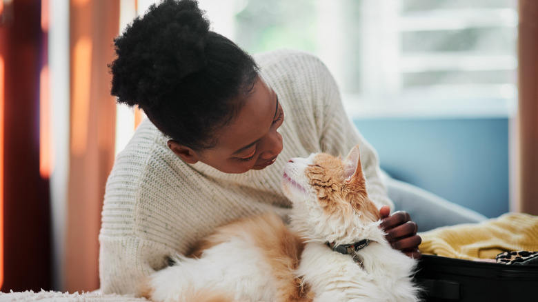 Woman and cat looking at each other