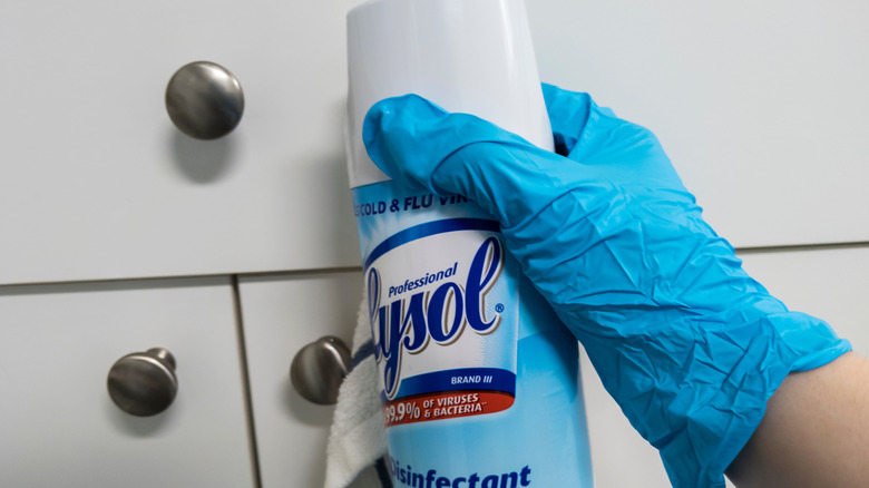 hand holding Lysol spray