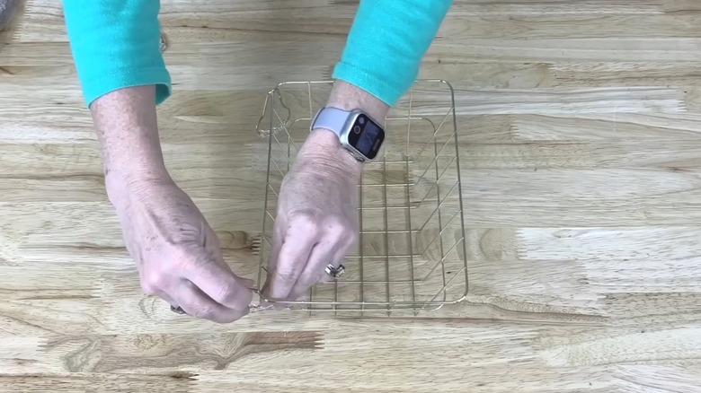 Woman crafting with a wire basket from Dollar Tree