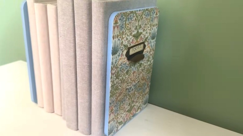 DIY bookend book organizers designed like floral notebooks on white shelf