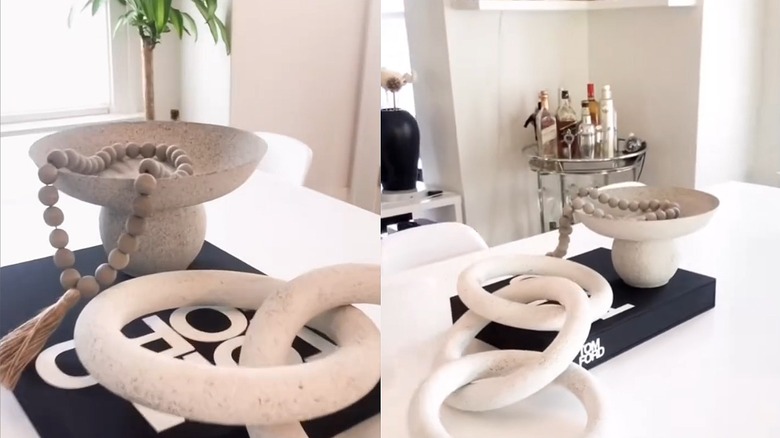 A DIY modern stone catch tray with decorative beads on a tabletop with chain link decor