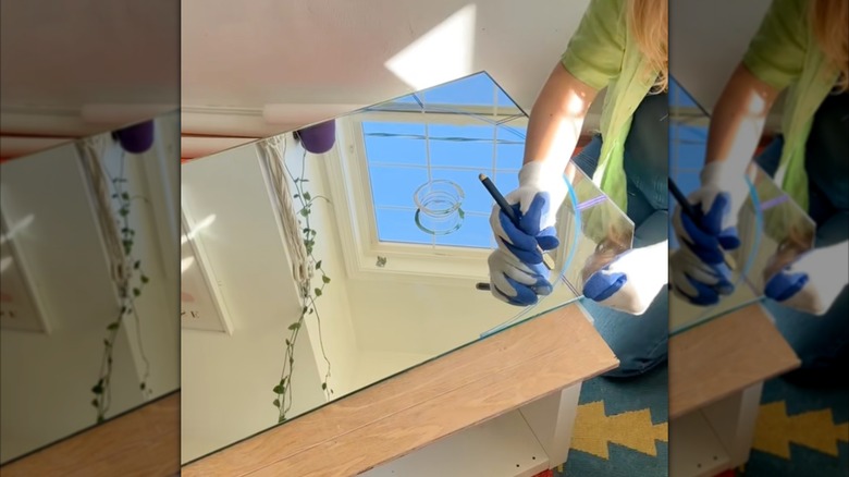 Woman cutting rectangular glass mirror