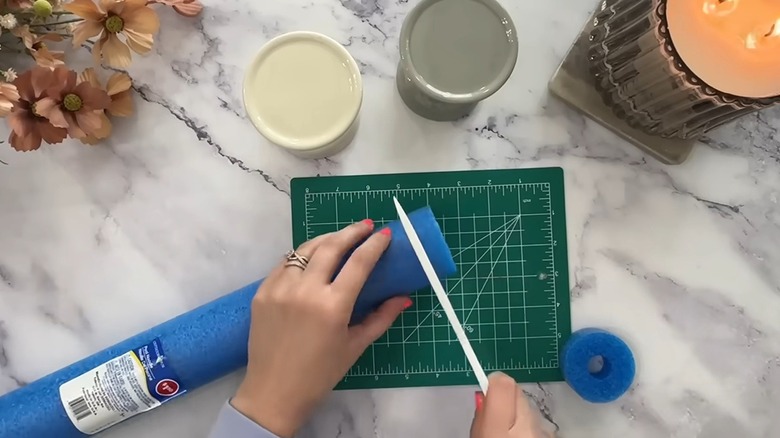 The Daily DIYer cuts a blue pool noodle to create home decor