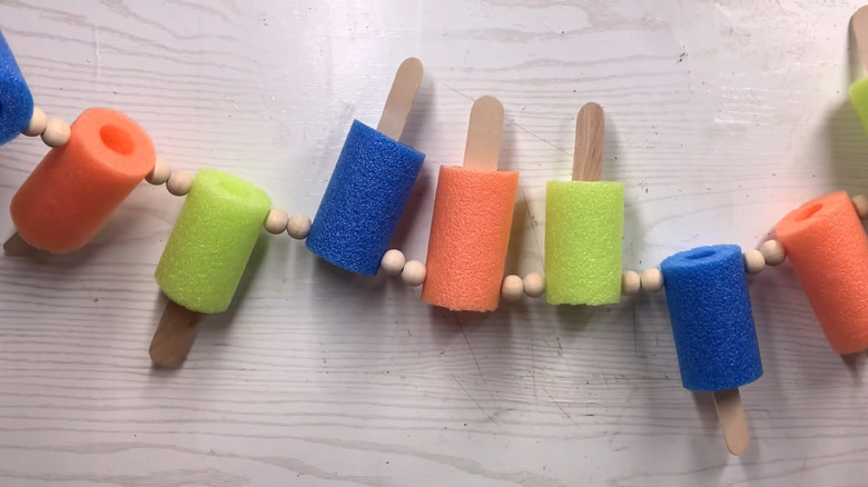 Popsicle garland made from sections of pool noodles and popsicle sticks