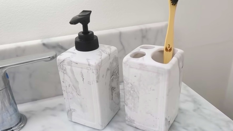 Dollar Tree soap and toothbrush holder with gray and white marbling on matching bathroom countertop