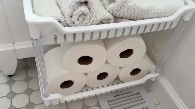 A Dollar Tree rack turned into toilet paper solution in bathroom
