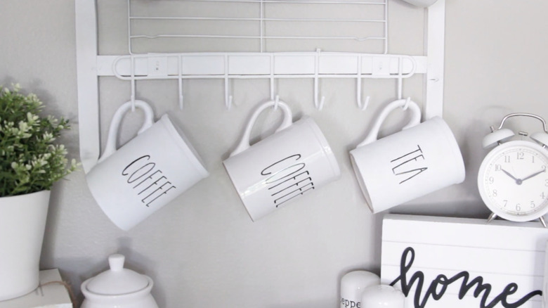 Coffee mugs hanging from Dollar Tree hooks