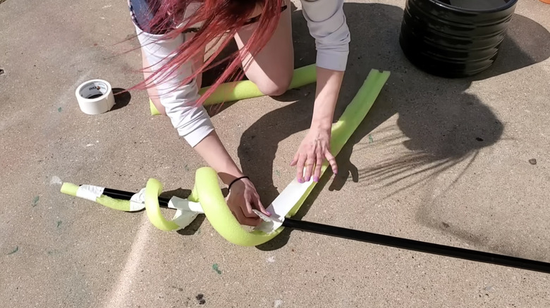 taping pool noodle to broom