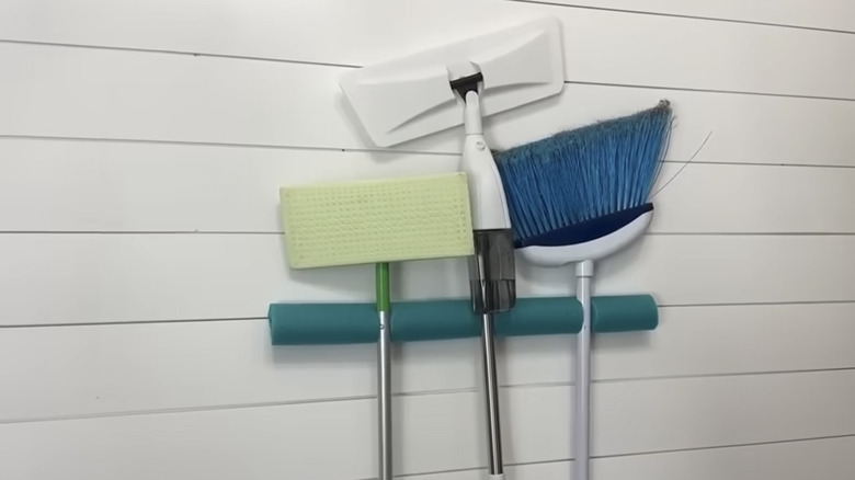 DIY pool noodle broom rack on wall
