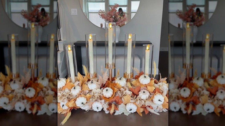 Fall centerpiece made from a pool noodle, fake foliage, and candle holders
