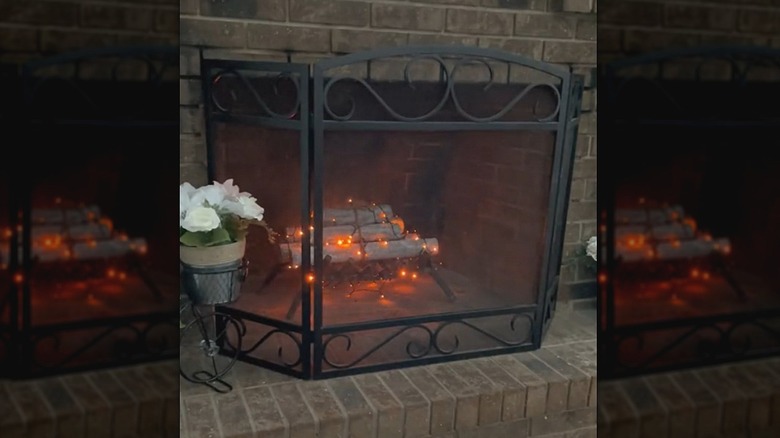Fireplace with pool noodle logs and lights inside