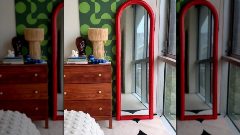 Floor -ength mirror with a red border made from pool noodles and fabric