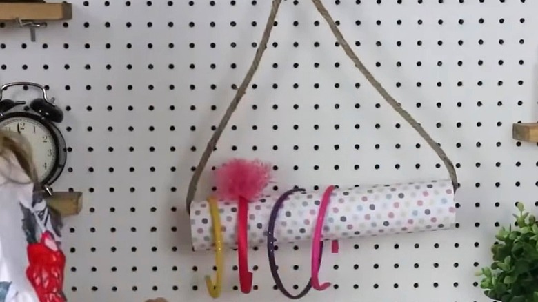 Hanging organizer made from a pool noodle hanging on a wall