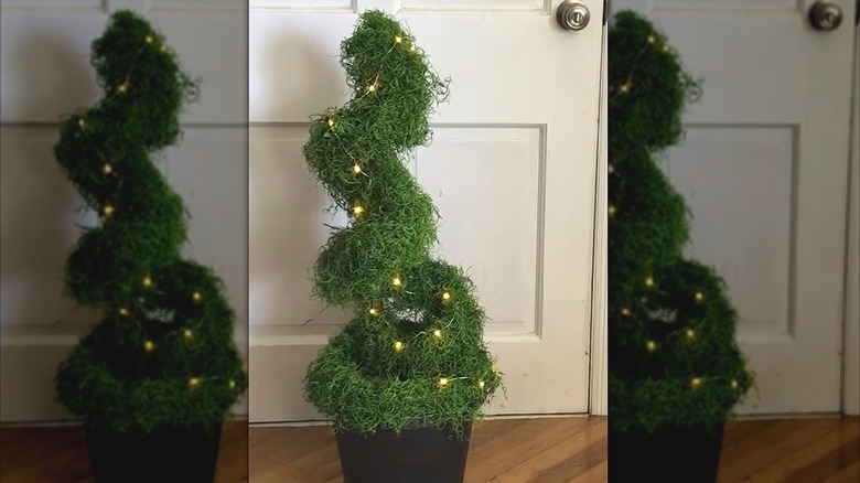 Faux topiary made from a pool noodle and greenery
