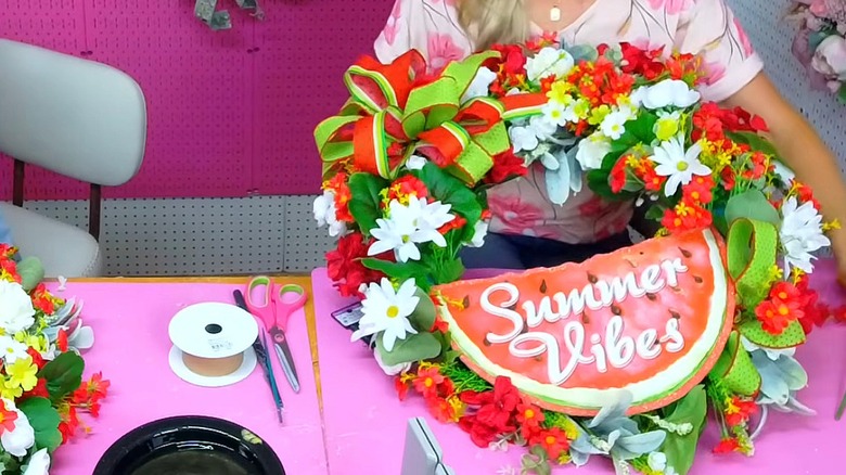 Summer wreath made of a pool noodle, sign, fake flowers, and ribbon