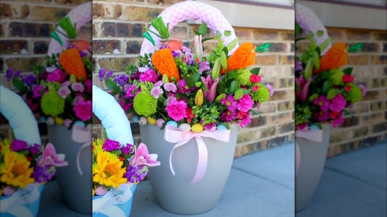 A colorful flower arrangement sits inside a spring decor made from a Dollar Tree planter and fabric-wrapped pool noodle