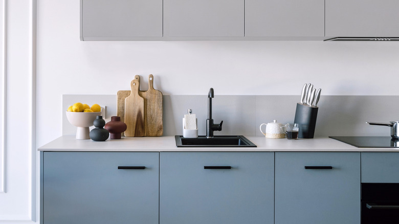 a modern kitchen sink area with knife block