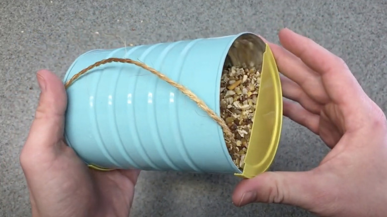 video of upcycling a metal coffee can into a bird feeder