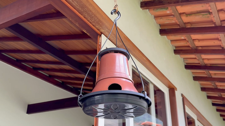 Hanging bird house made from plastic plant pots
