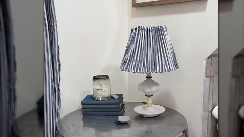 Striped shower curtain lampshade with matching decor on side table