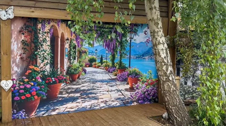 Shower curtain village mural used as backdrop in outdoor porch area