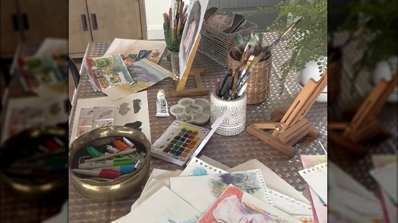 Clear embossed shower curtain underneath crafting supplies on dining table