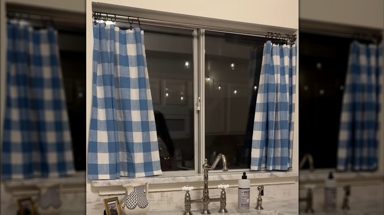 Hemmed blue checkered curtains over vintage kitchen sink setup with nickel-finished appliances