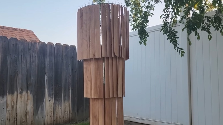 Mini chandelier made from wood strips and a tomato cage