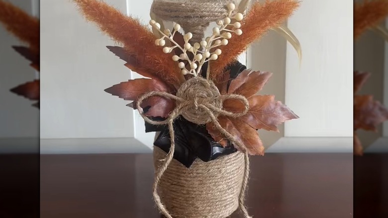 A pretty bottle-like centerpiece made using a wine glass