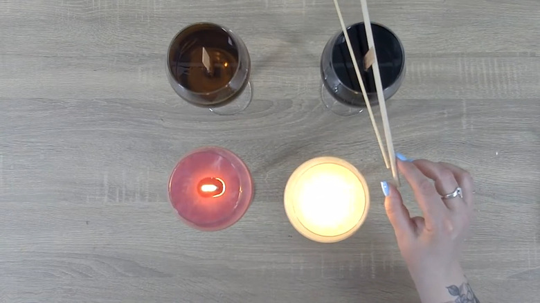 Lit and unlit wine glass candles on a table