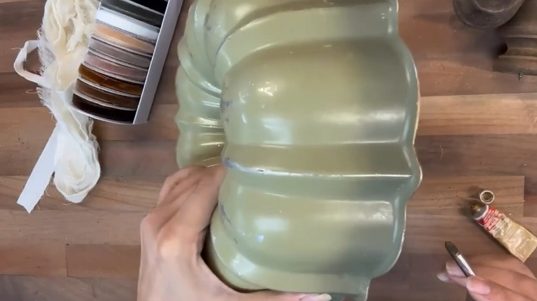 Person painting an old Bundt pan