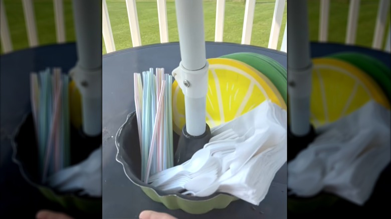 Bundt pan hold on a patio table by an umbrella post holding serving items