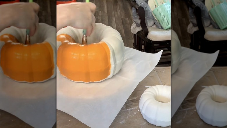 A hand painting rustic-looking pumpkins made from old bundt pans