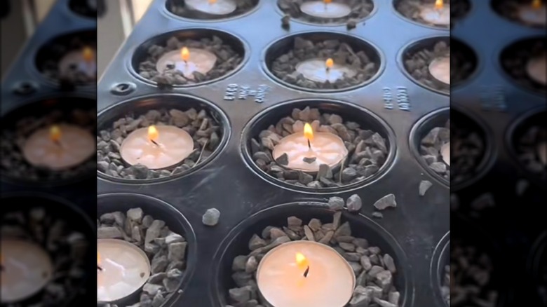 Old muffin pan filled with gravel and tealight candles to deter mosquitoes and bugs