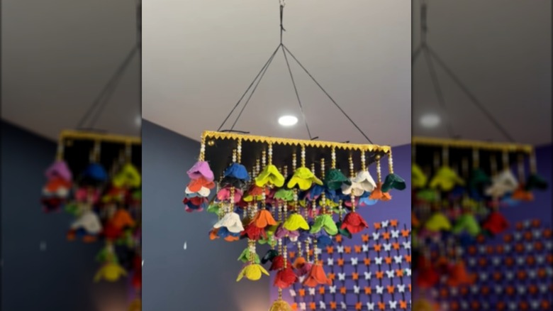Hanging floral display with colorful flowers and yellow trim around the top