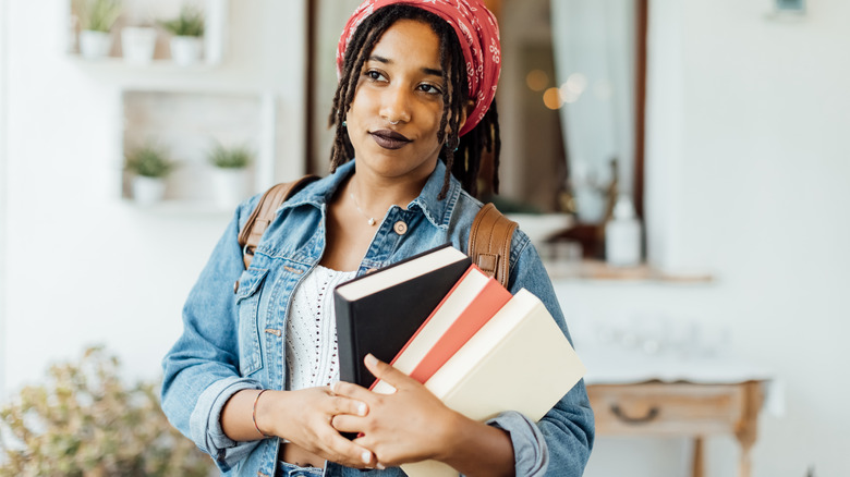 A woman holding a few books