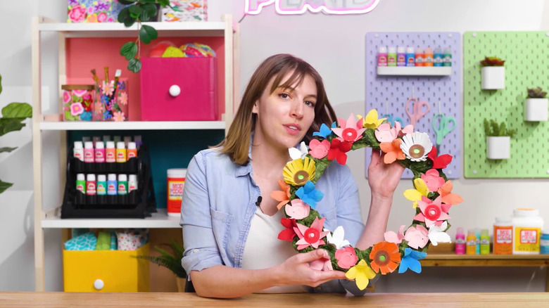 Person holding a wreath made of egg cartons and K-cups