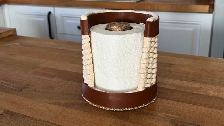 Toilet paper holder with woven sides made from a plastic lid
