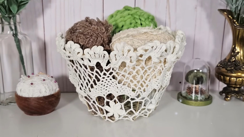 Storage basket made by covering a wire basket with a doily