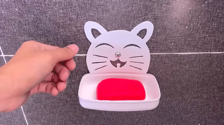 a soap dish made from a repurposed plastic container