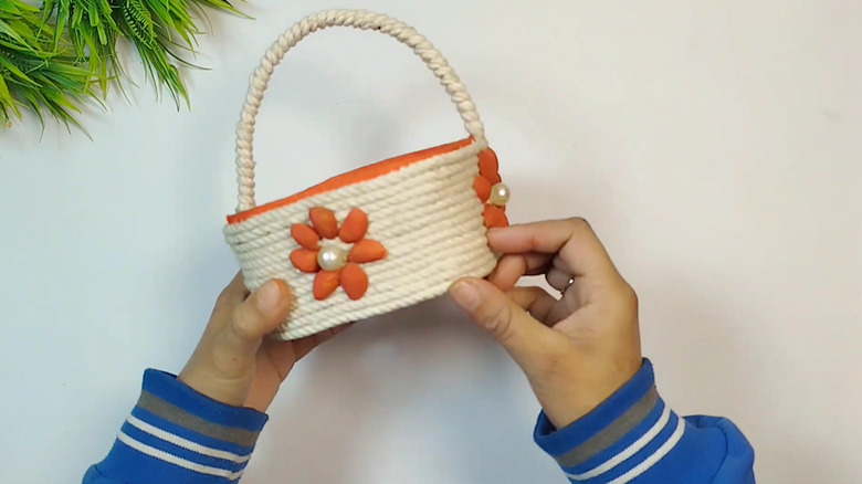 A storage basket made from a repurposed ice cream container
