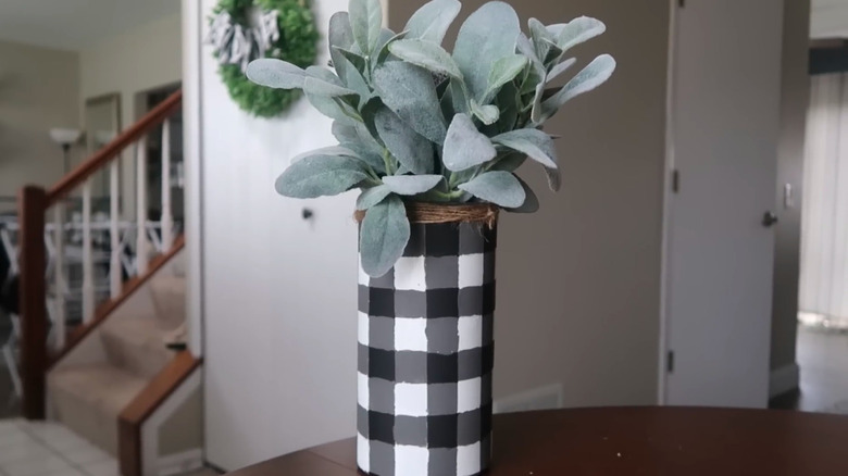A vase crafted from a plastic disinfectant wipes container