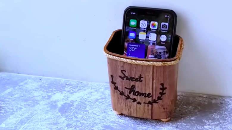 a phone caddy made from a cocoa canister