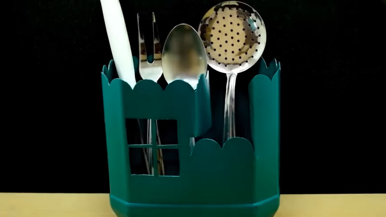 a silverware caddy made from an upcycled plastic container