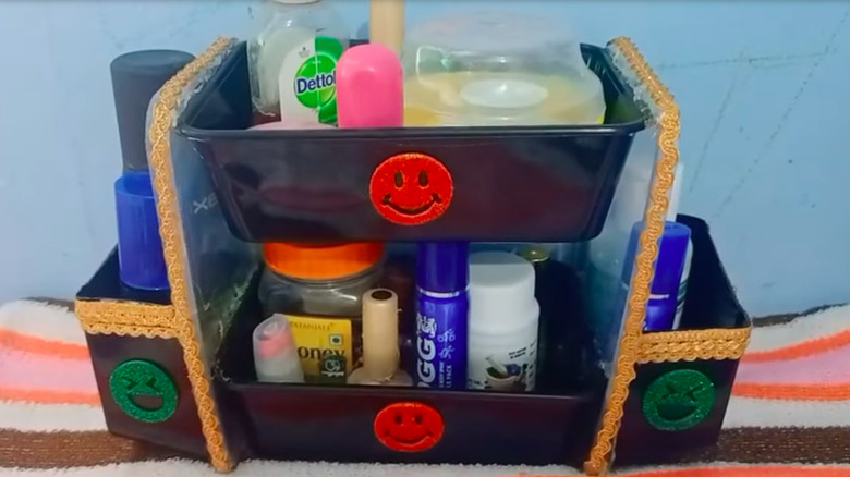 a two-tier storage system made from plastic takeout boxes