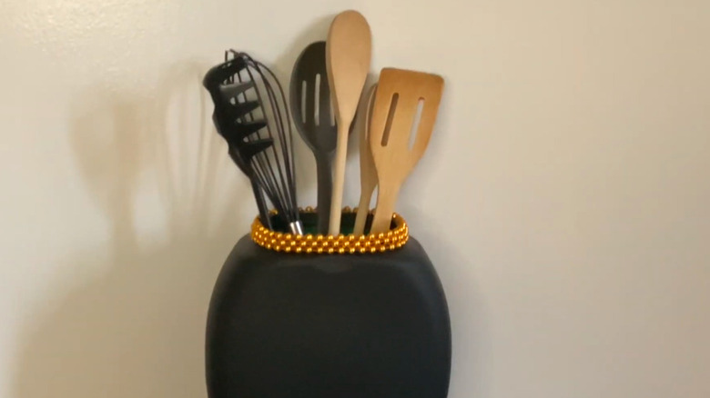 a utensil holder made from a repurposed laundry pods container