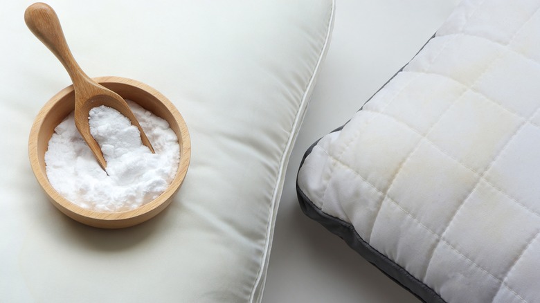 White powder in a wood bowl and stained pillows